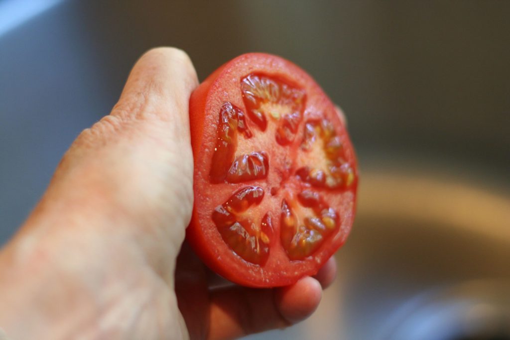 Holding Tomato Half for Squeezing