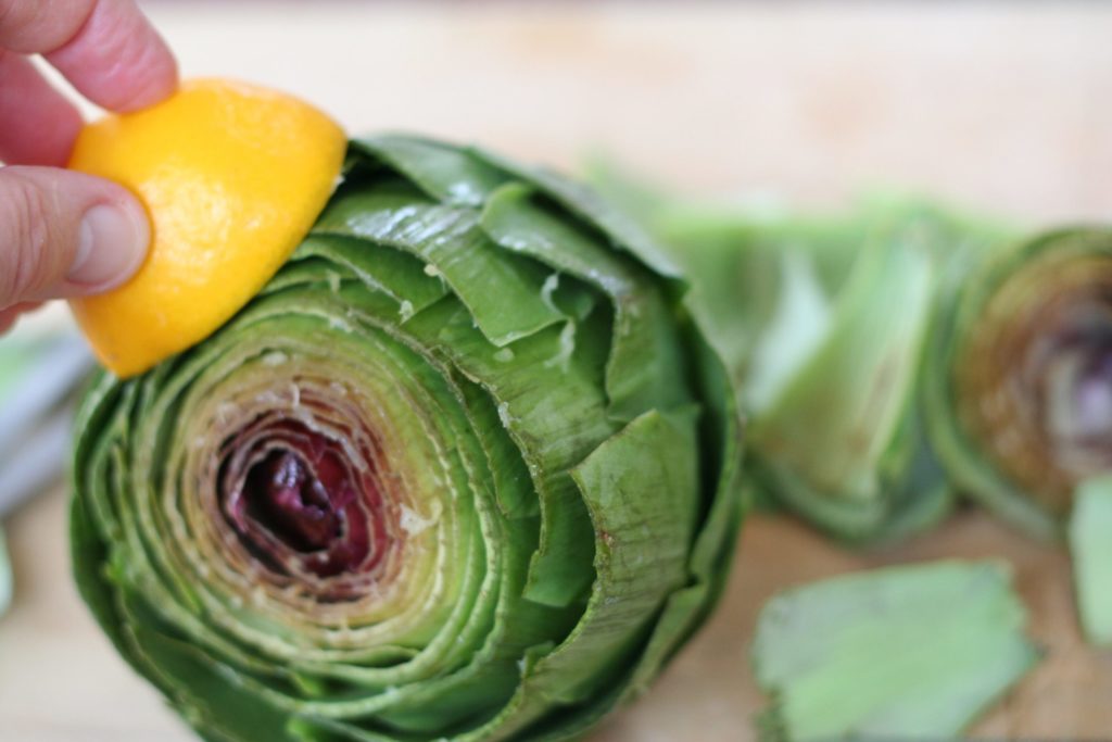 Rubbing the Trimmed Leaves of an Artichoke with Lemon